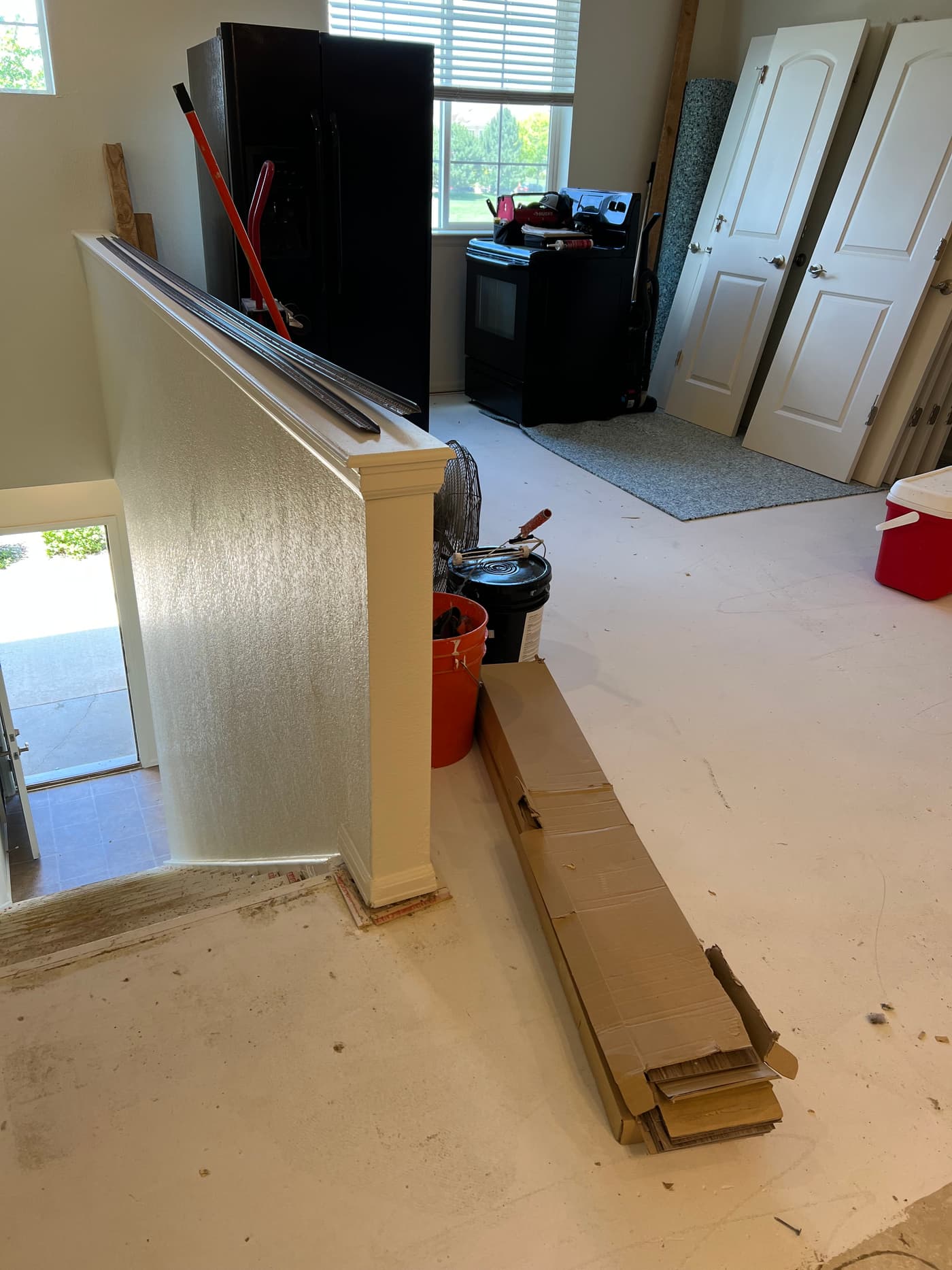 Wood-look plank boxes and tools during a kitchen flooring install