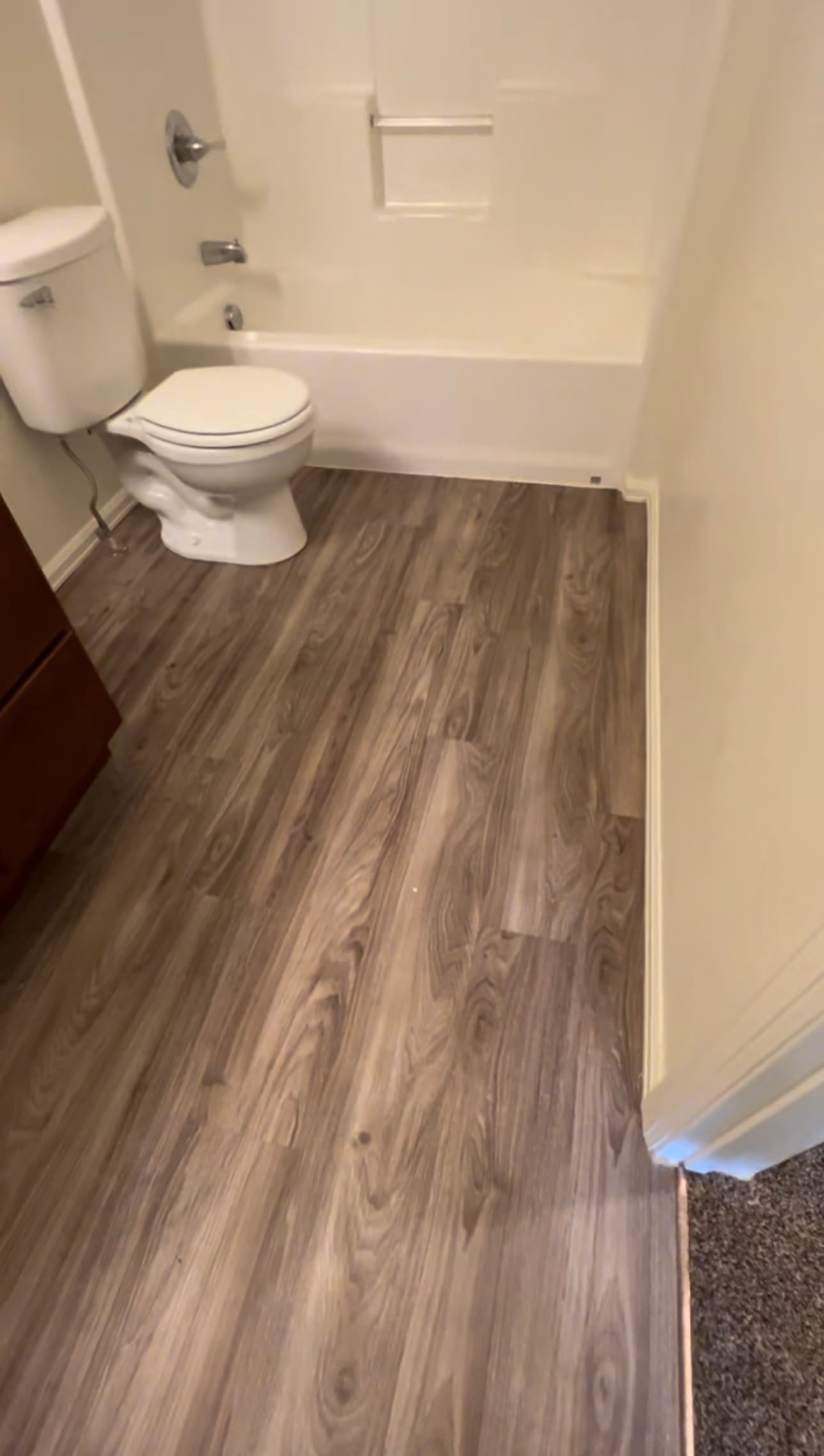 Grey-brown wood-look vinyl plank in a bathroom